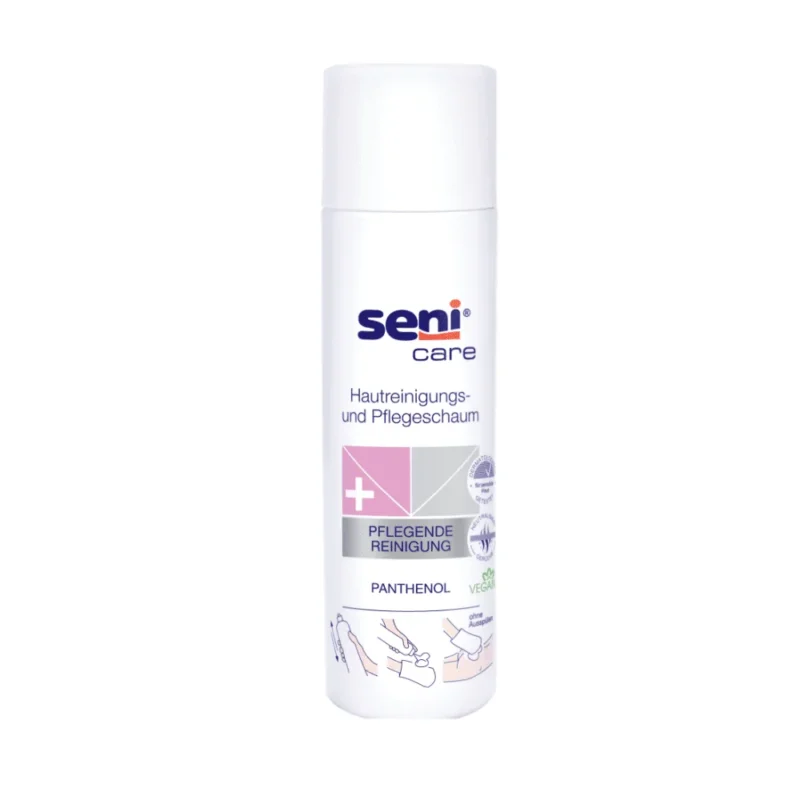 Abgebildet ist eine weiße, zylindrische 500-ml-Flasche Seni Care Hautreinigungs- und Pflegeschaum der TZMO Deutschland GmbH. Das deutsche Etikett mit Anwendungsillustrationen hebt Panthenol und veganfreundliche Inhaltsstoffe für empfindliche Haut hervor. Es verfügt über einen weißen Verschluss.