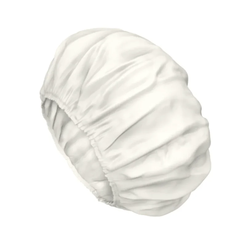 Eine weiße Satinhaube mit gerafften elastischen Kanten zum Schutz der Haare, die an die sanfte Pflege der TENA ProSkin Shampoo Cap Waschhaube erinnert.