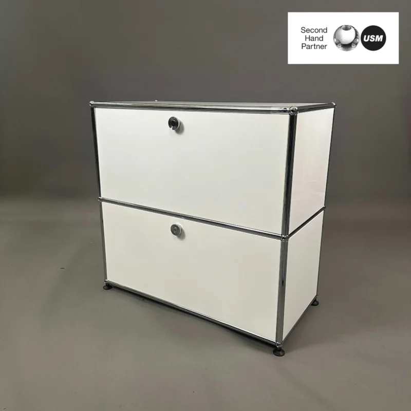 USM Haller white sideboard with two compartments and drop-down doors in modern design