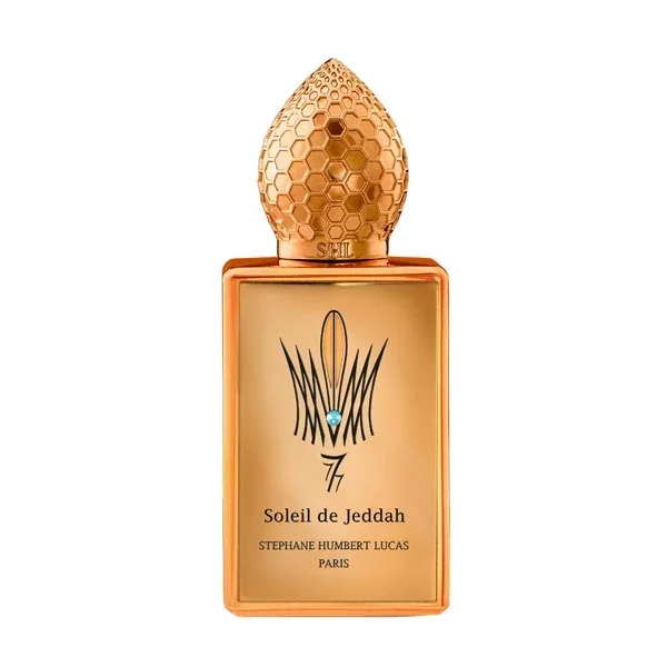 Stéphane Humbert Lucas 777 - Mango Kiss Parfumflakon mit goldfarbenem Design und strukturiertem Deckel vor weißem Hintergrund